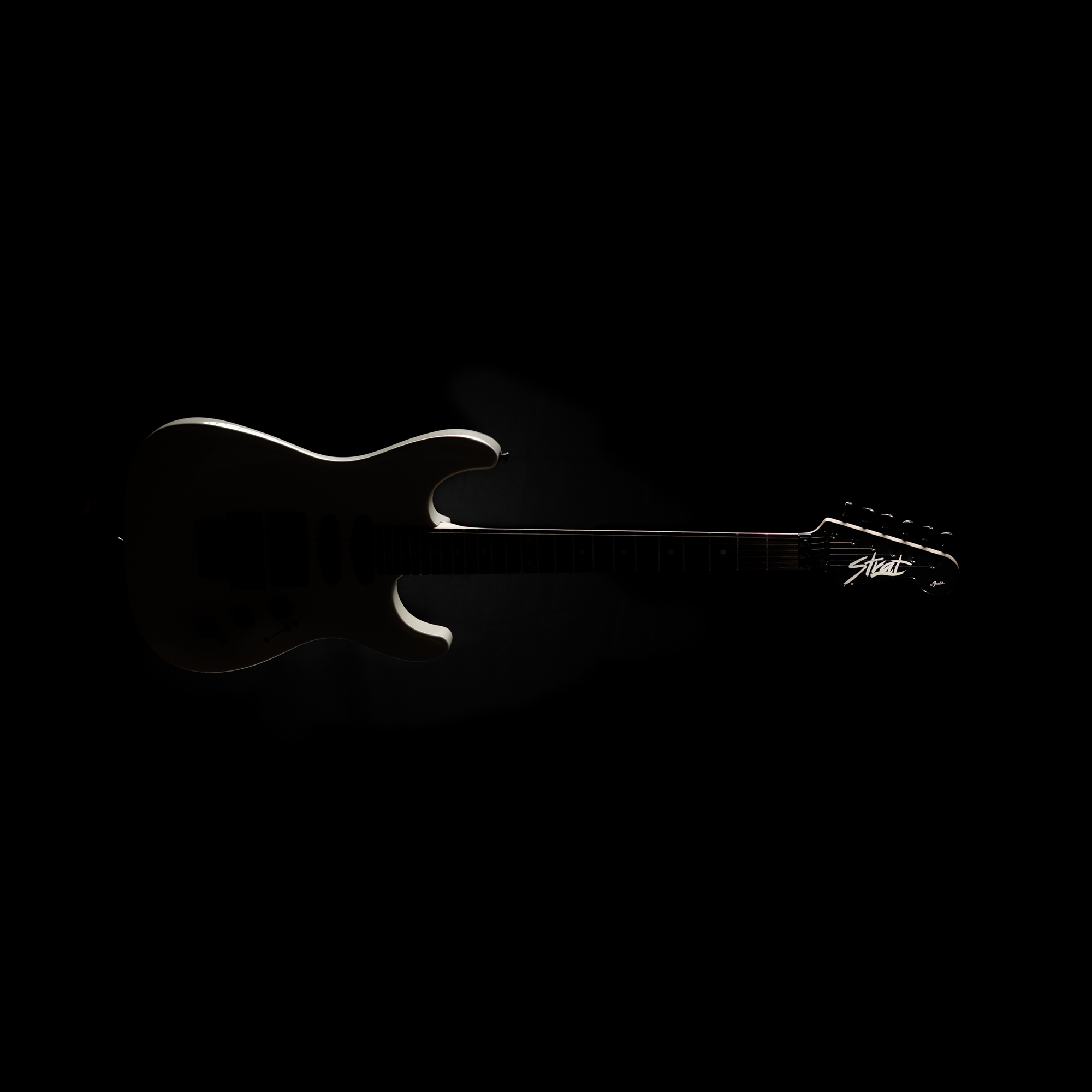 Product photography of Fender HM Strat silhouette illuminated by rim lighting.